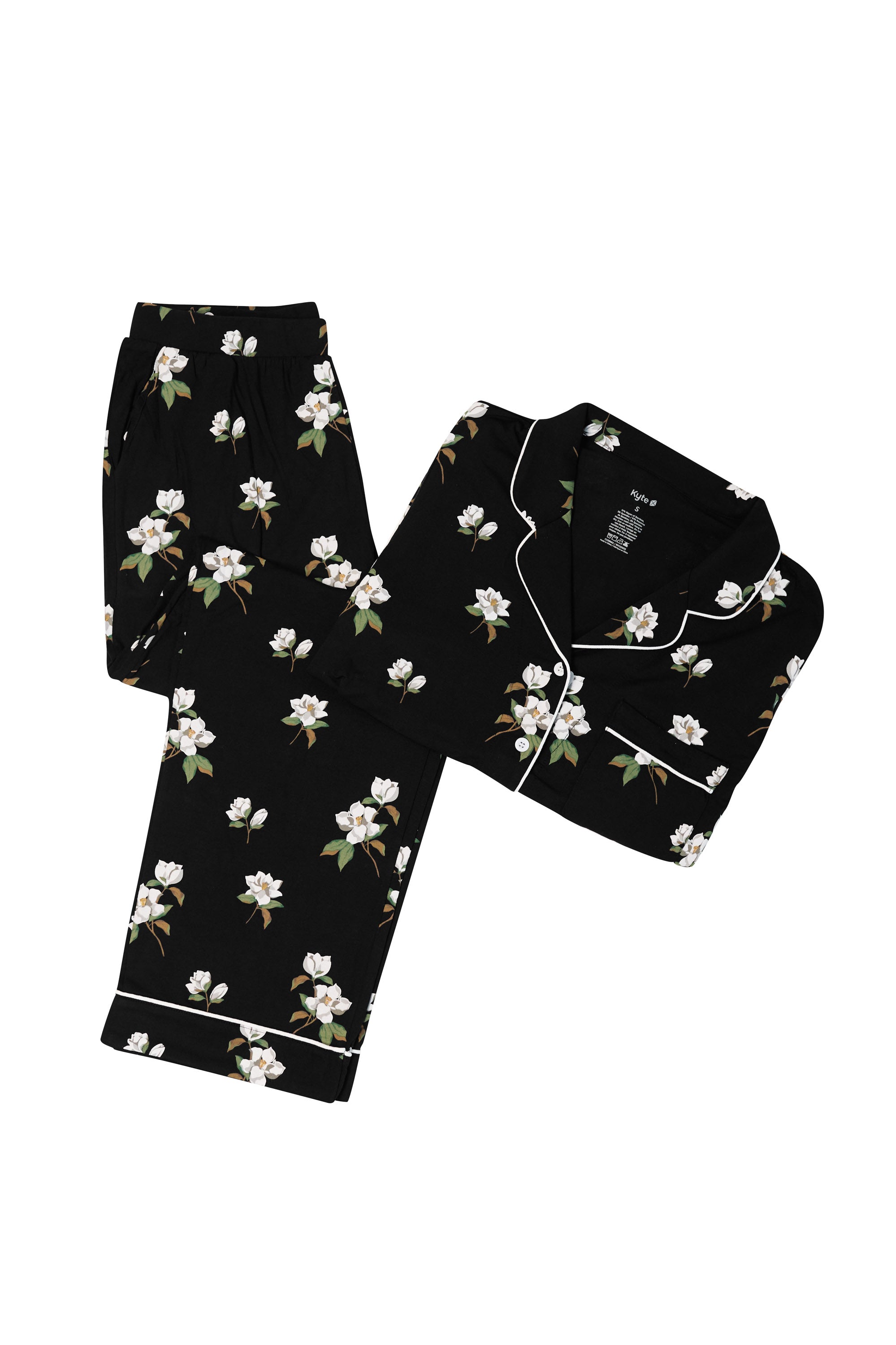 Black pajama set with white magnolia flower print on a white backdrop
