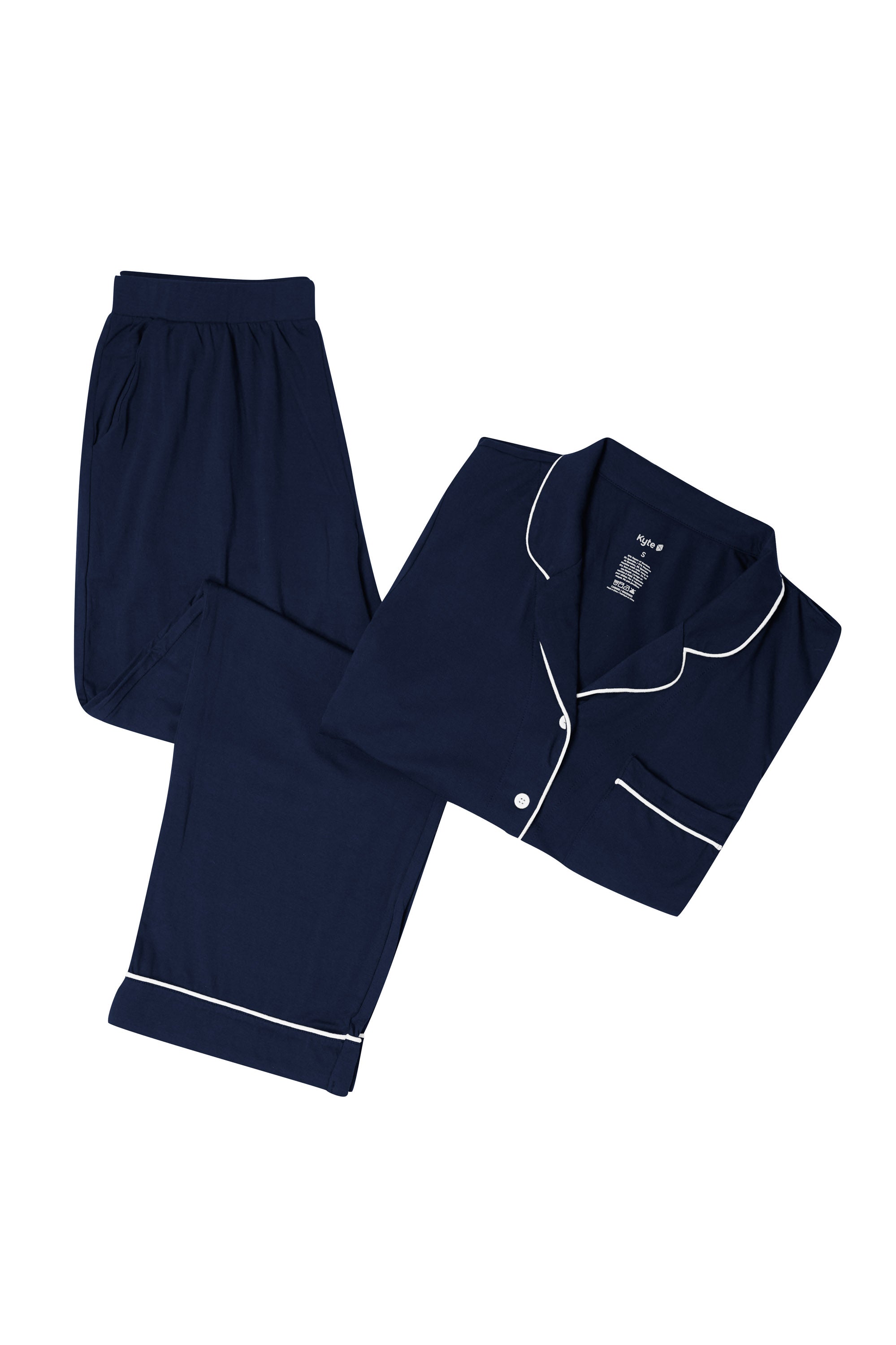 Navy pajama set with white piping on a white backdrop