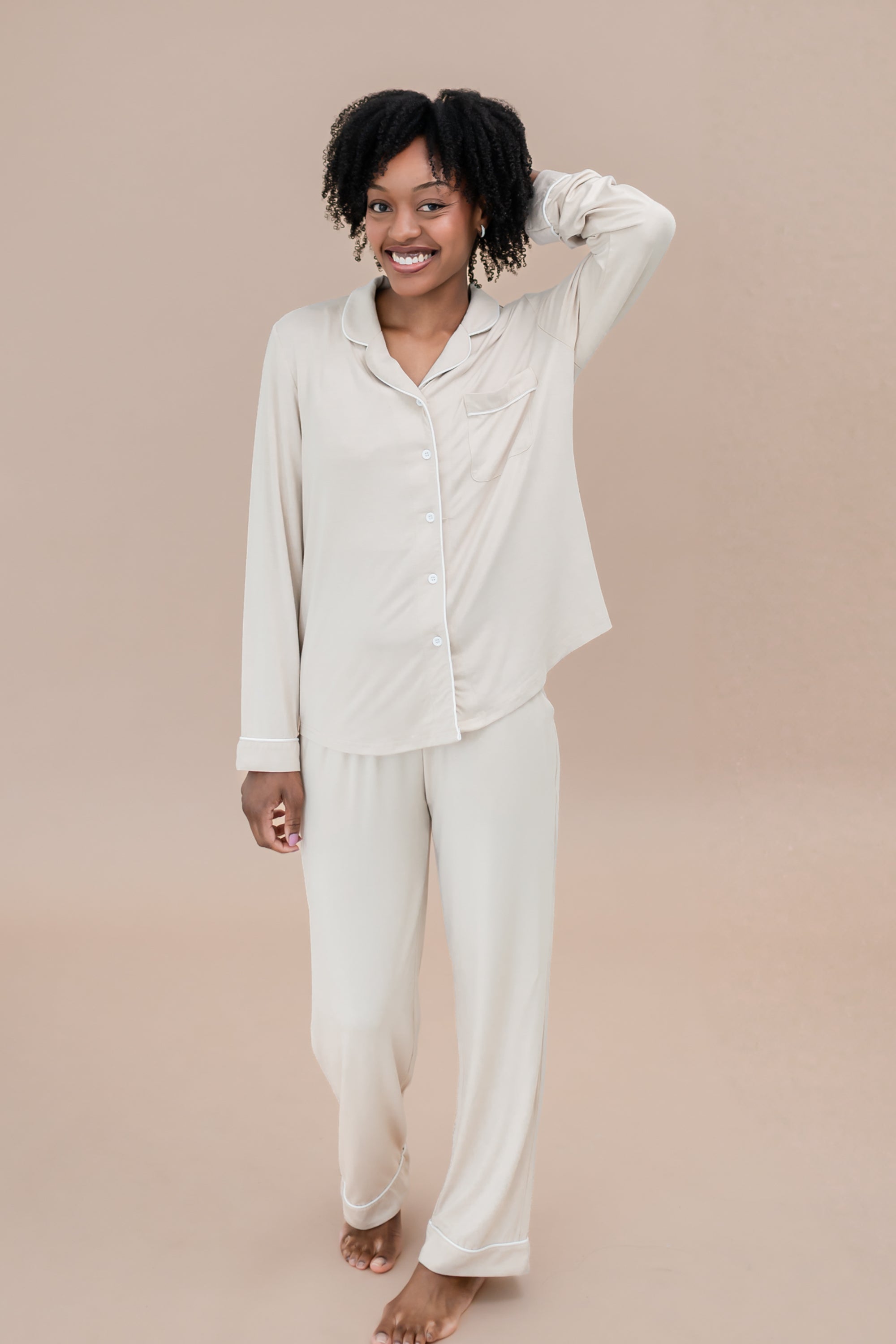 Woman wearing a bisque pajama set against a beige background