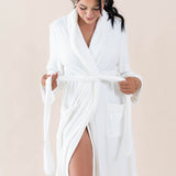 Model holding the ends of the waist tie on the Adult Robe in Cloud
