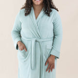 Model wearing the Adult Robe in Sage with one hand in pocket