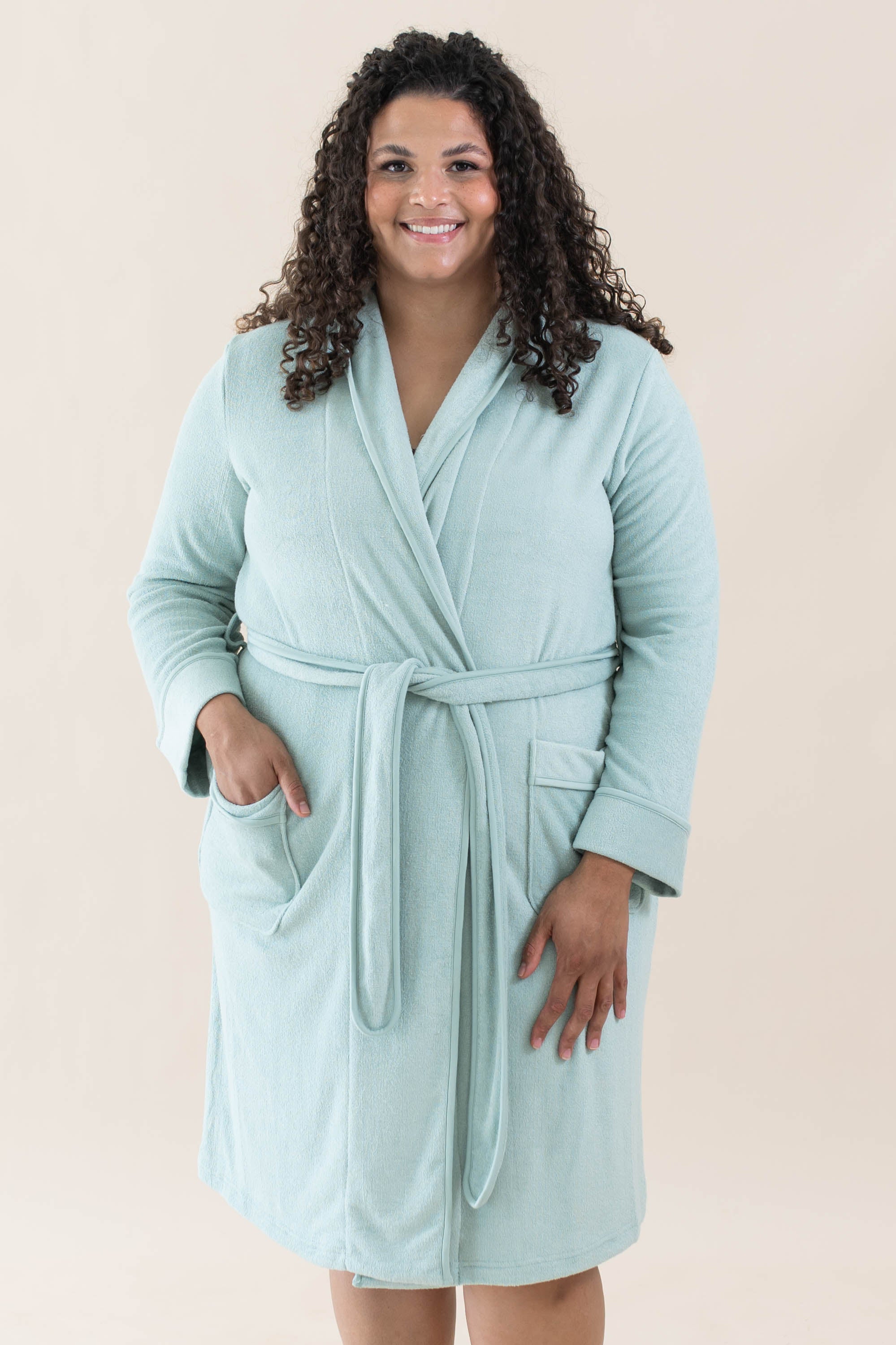 Model wearing the Adult Robe in Sage with one hand in pocket