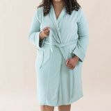 Model wearing the Adult Robe in Sage tied up while holding the ends of the tie in front of her