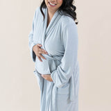 Expectant mother wearing the Adult Robe in Storm while cradling her baby bump