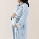 Expectant mother holding her baby bump while wearing the Adult Robe in Storm