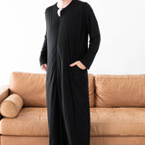 Male model wearing the Adult Sleep Bag Walker in Midnight with one hand in the pocket