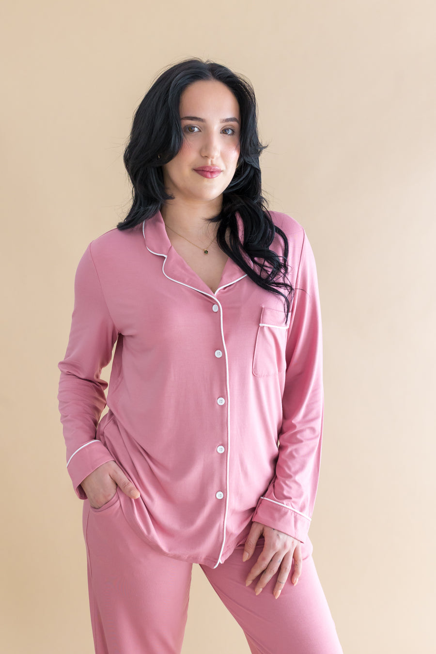 Woman modeling the Long-Sleeved Women's Pajama Set in Apple Blossom with Cloud Trim in front of a light taupe background