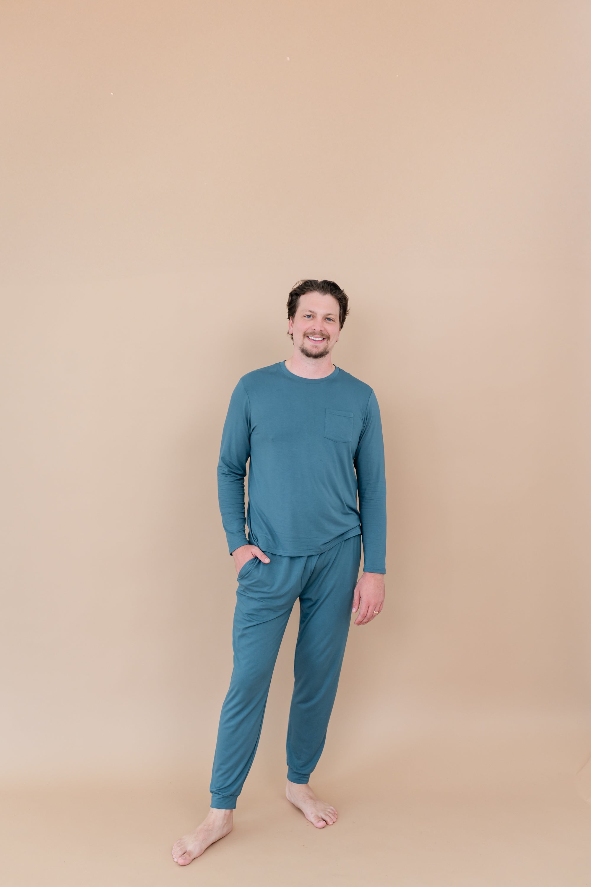 Smiling male model wearing Men's Jogger Set in Atlantic