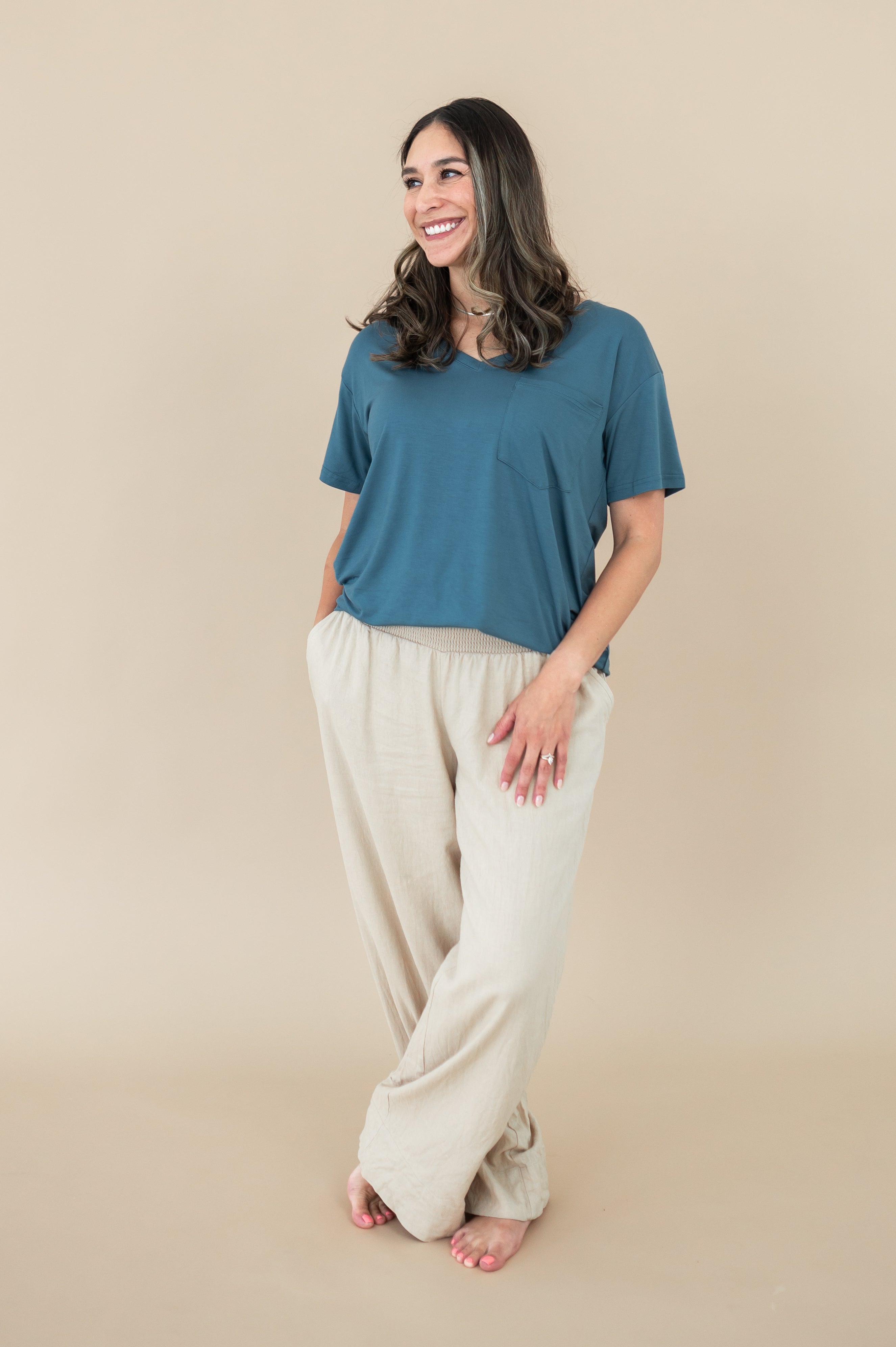 Smiling model wearing Kyte Women's V Neck in Atlantic