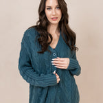 Woman modeling the buttoned up Chunky Cable Knit Cardigan in Atlantic