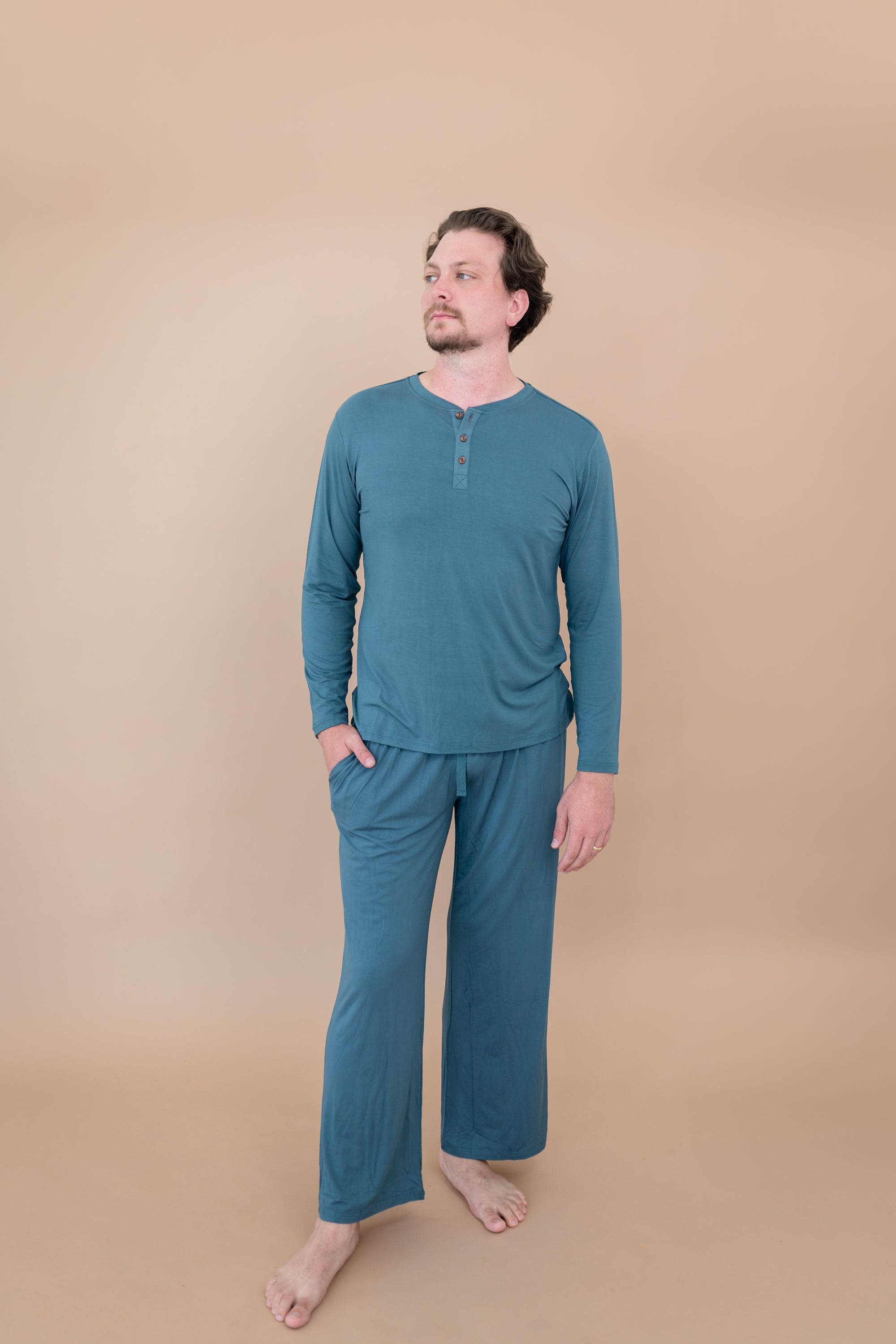 Male model wearing the Long Sleeve Henley Top in Atlantic and matching Lounge Pants