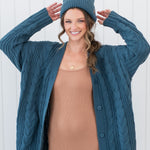 Model wearing the Chunky Cable Knit Cardigan in Atlantic, matching beanie and ribbed cami dress in Latte