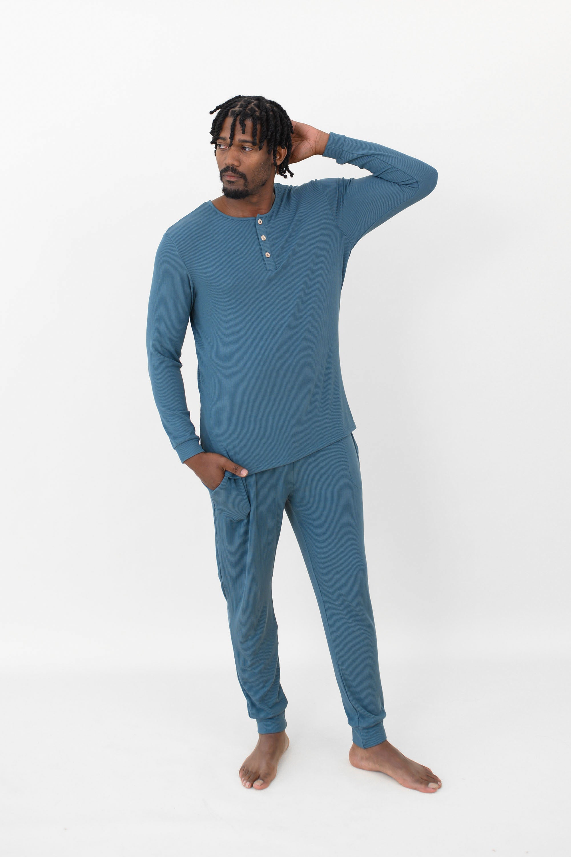 Male model wearing the Men's Ribbed Henley Set in Atlantic with one hand on head