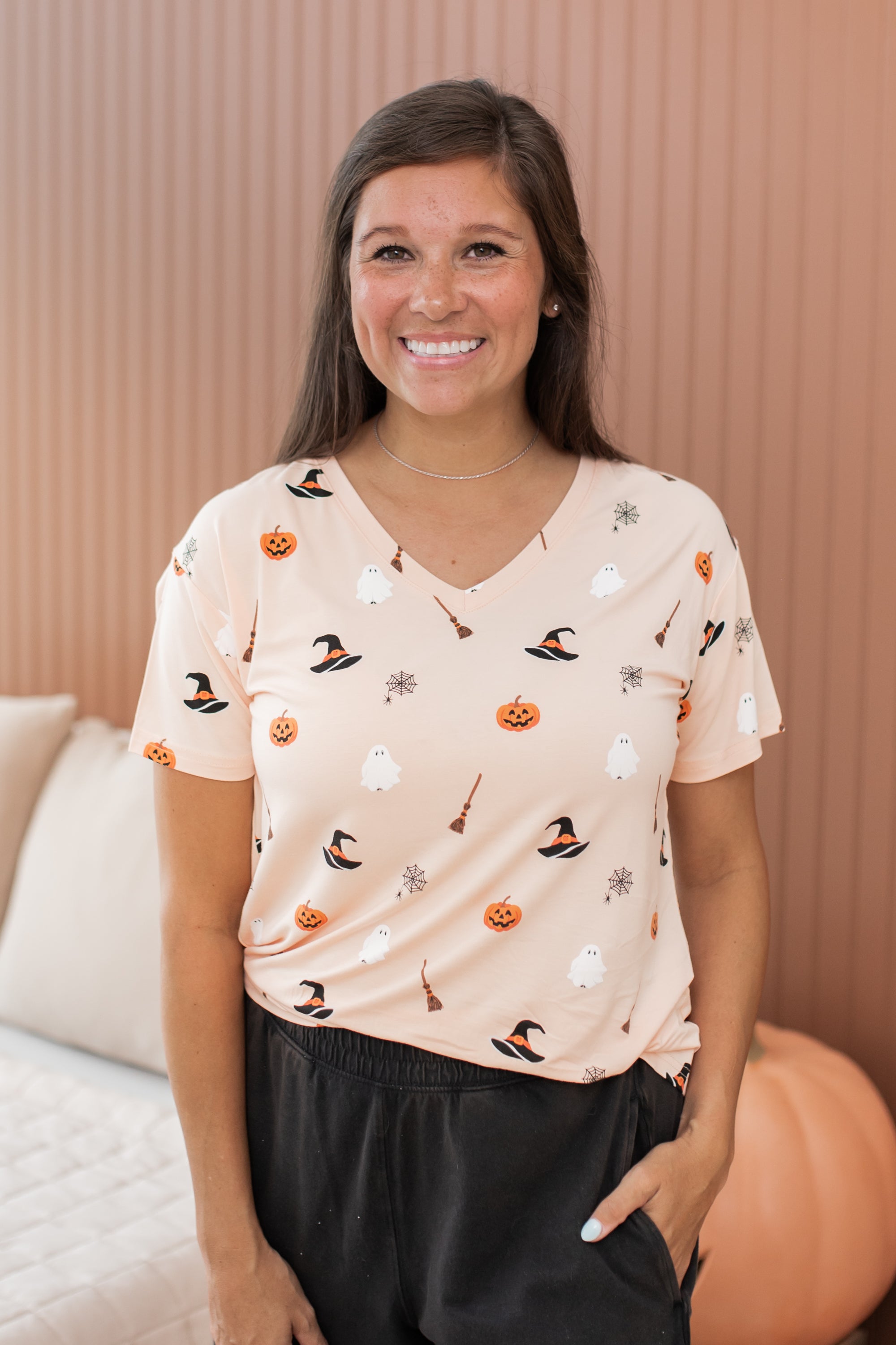 Model smiling with hand in pocket while wearing the Women's V-Neck in Bewitched