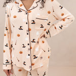 Model wearing Women's Long Sleeve Halloween Pajama Set in Bewitched with black trim