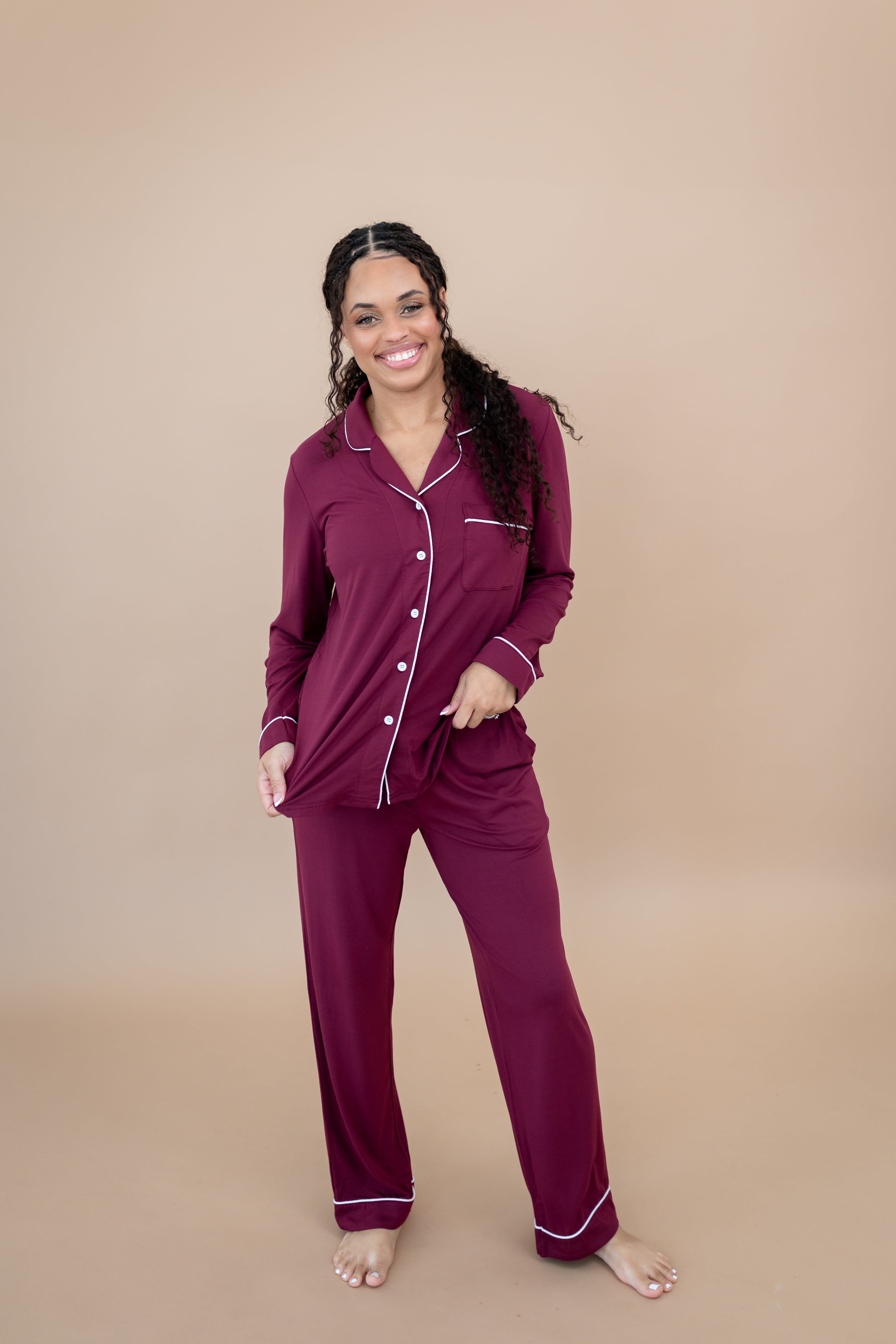 Model looking forward, smiling and wearing the Women's Long Sleeve Pajama Set in Burgundy
