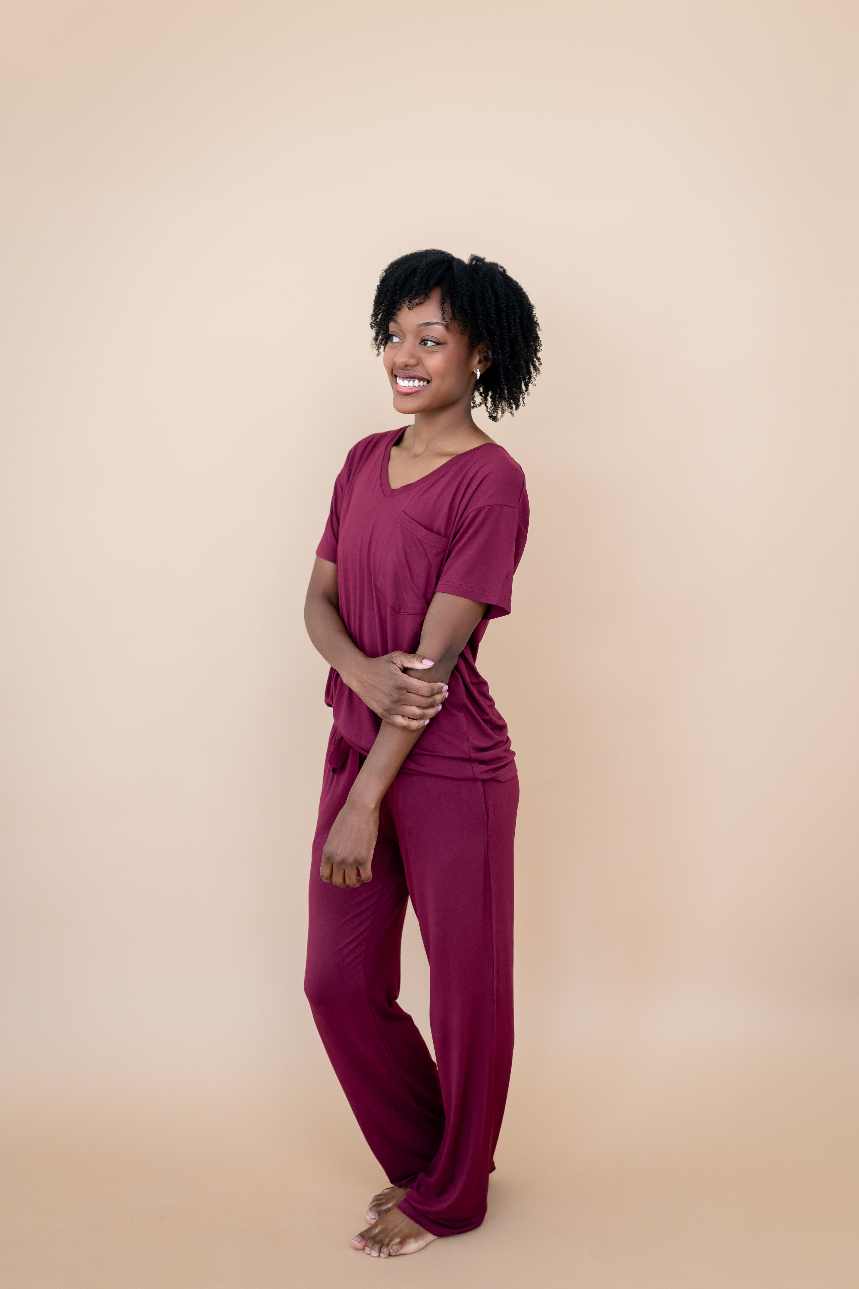 Smiling model wearing matching V Neck and Lounge Pants in Burgundy