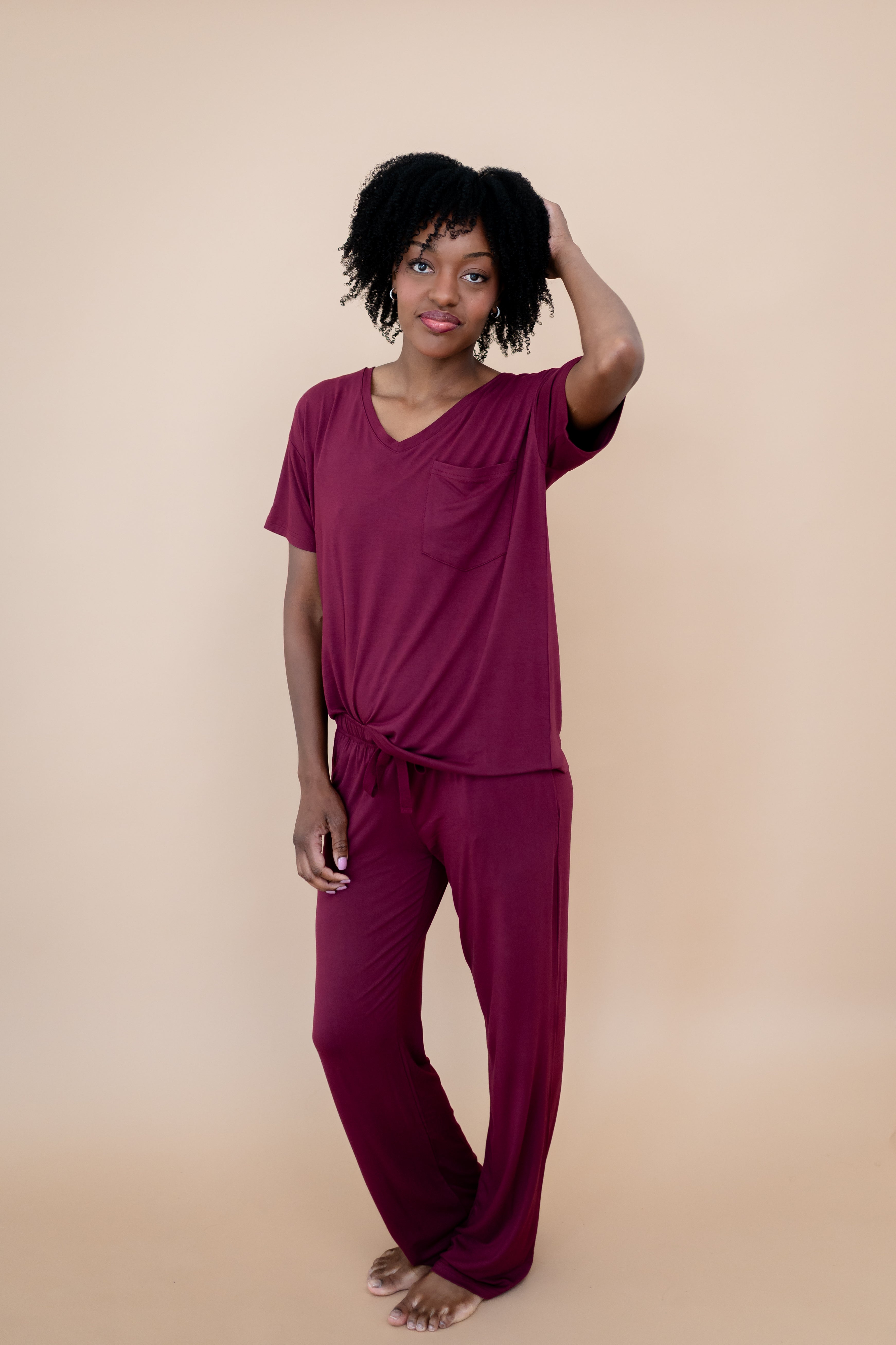 Model with hand in her hair while wearing the Lounge Pants in Burgundy