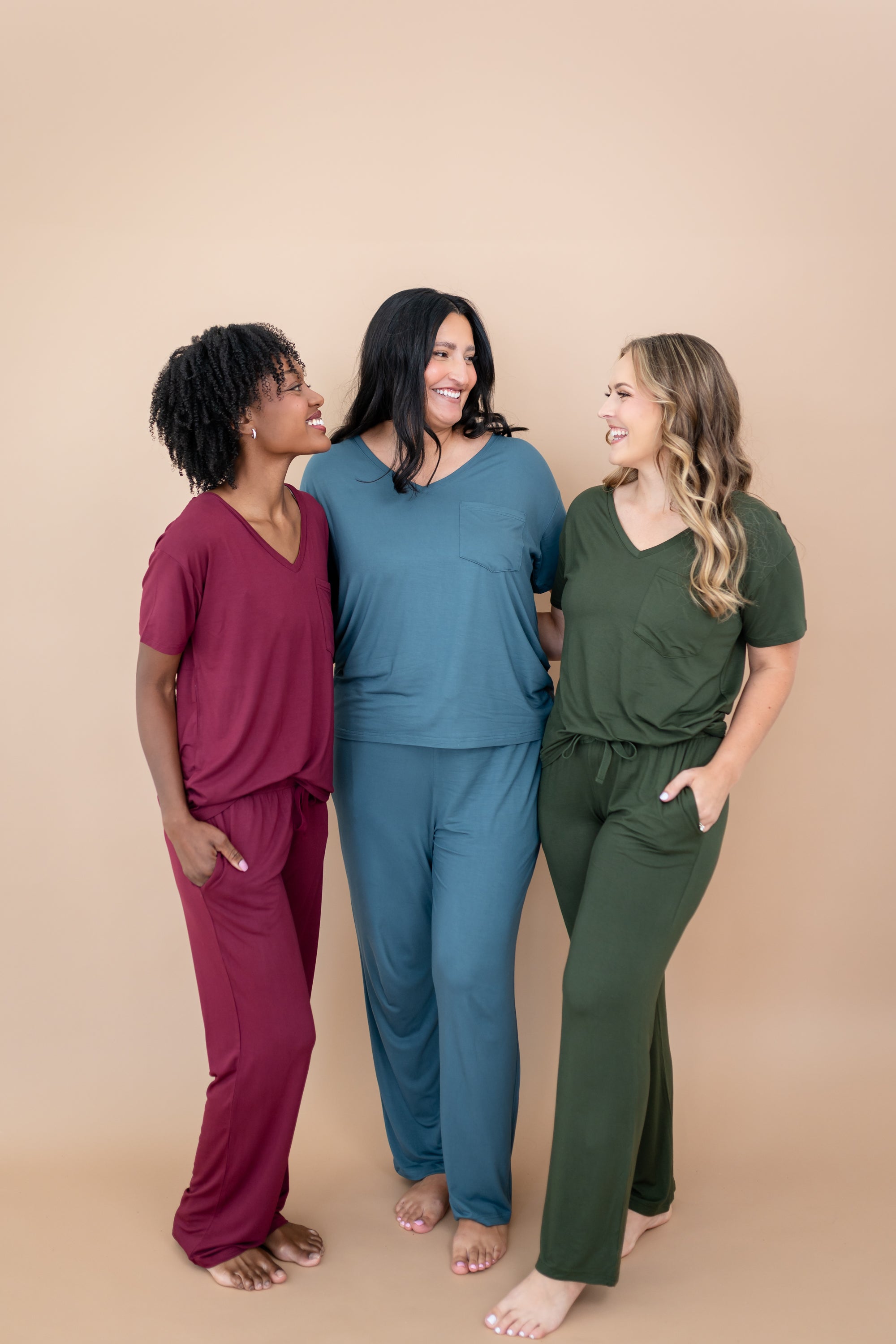 Women standing together modeling the V Neck and Lounge Pants in Burgundy, Atlantic and Fir
