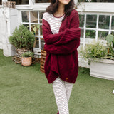 Model wearing the Women's RIbbed Henley Set in Burgundy Stripe and Cable Knit Cardigan in Burgundy while holding arms across her body