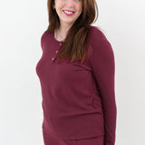 Close up on the top of the Women’s Ribbed Henley Set in Burgundy shown on a smiling female model