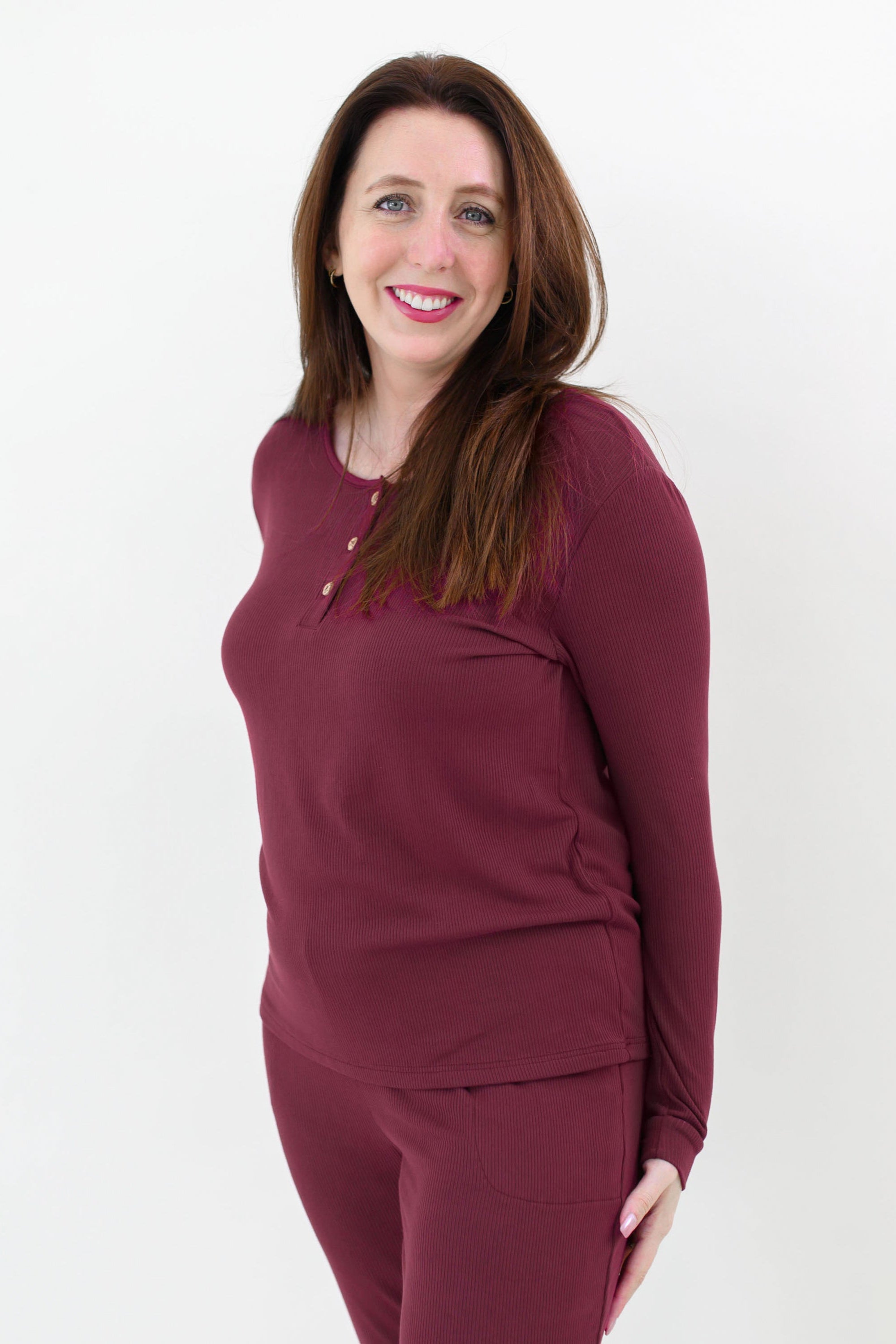 Close up on the top of the Women’s Ribbed Henley Set in Burgundy shown on a smiling female model