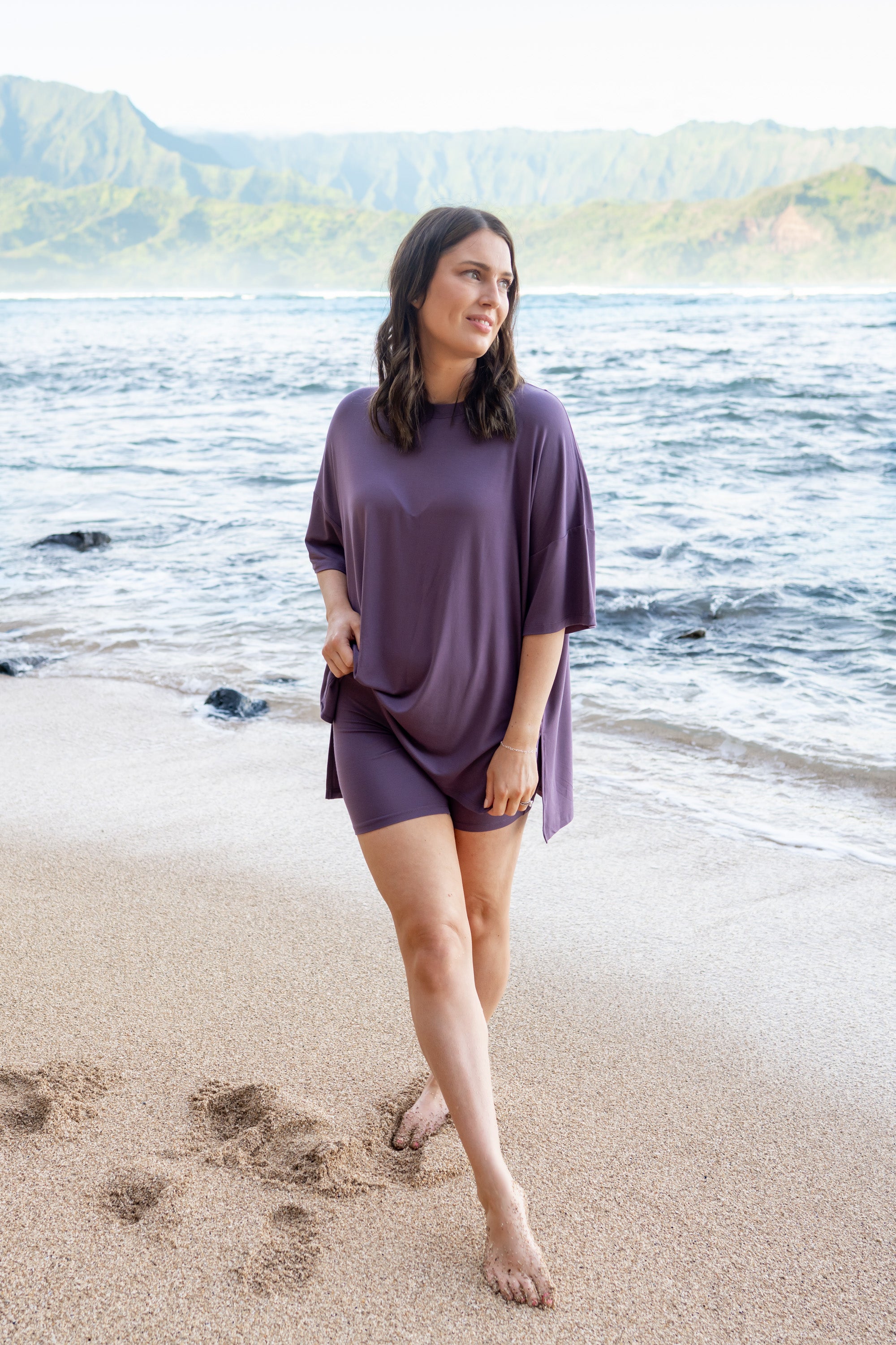 Female model standing in the sand on the beach wearing the Women’s Biker Short Set in Currant