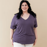 Model wearing Women’s Relaxed Fit V-Neck in Currant paired with white jeans