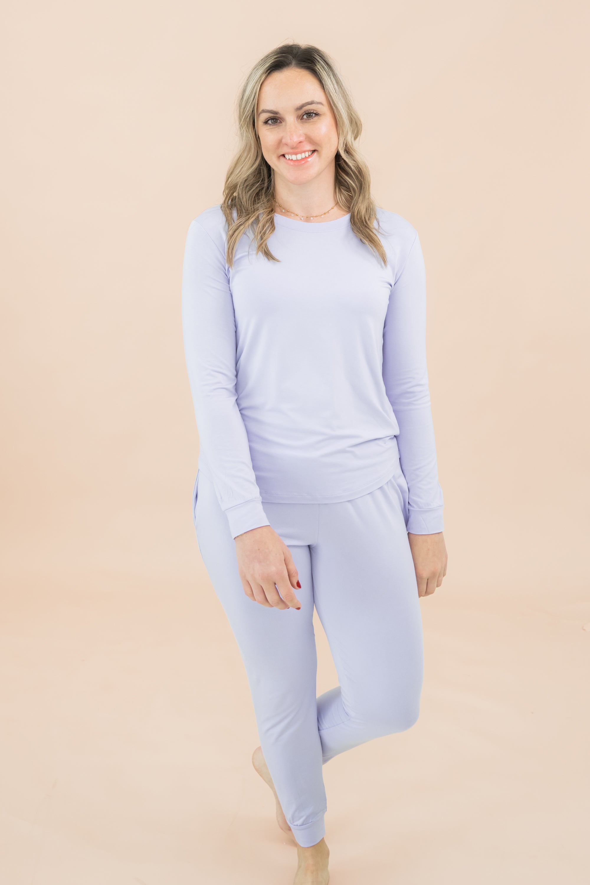 Woman modeling matching jogger set in a lilac color