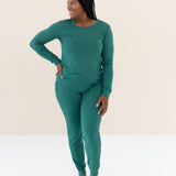 Woman modeling Women's Jogger Pajama Set in Emerald with hand on hip looking off to the side
