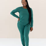 Woman modeling Women's Jogger Pajama Set in Emerald with hand on hip with braided hair in front of shoulder