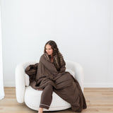 Model wearing the Long Sleeve Pajama Set and wrapped in Bamboo Quilt Blanket in Espresso 2.5
