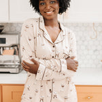 Woman with arms around her torso while modeling the Kyte Bamboo Long-Sleeved Women's Pajama Set in Espresso Martini