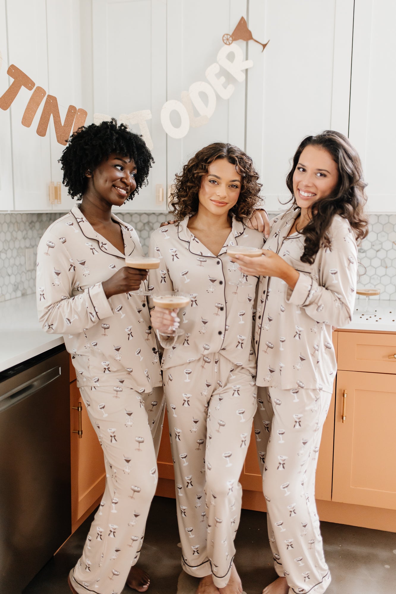 Three women standing next to each other while modeling the Bamboo Long-Sleeved Women's Pajama Sets in Espresso Martini