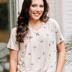 Smiling model wearing the Women's Relaxed Fit V-Neck in Espresso Martini paired with light jeans