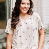 Smiling model wearing the Women's Relaxed Fit V-Neck in Espresso Martini paired with light jeans