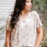 Woman looking to the side while modeling the Women's Relaxed Fit V-Neck in Espresso Martini