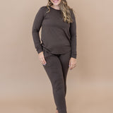 Smiling model wearing the Kyte Women's Jogger Set in Espresso