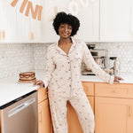 Model standing in front of a counter while modeling the Bamboo Long-Sleeved Women's Pajama Set in Espresso Martini
