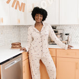 Model standing in front of a counter while modeling the Bamboo Long-Sleeved Women's Pajama Set in Espresso Martini