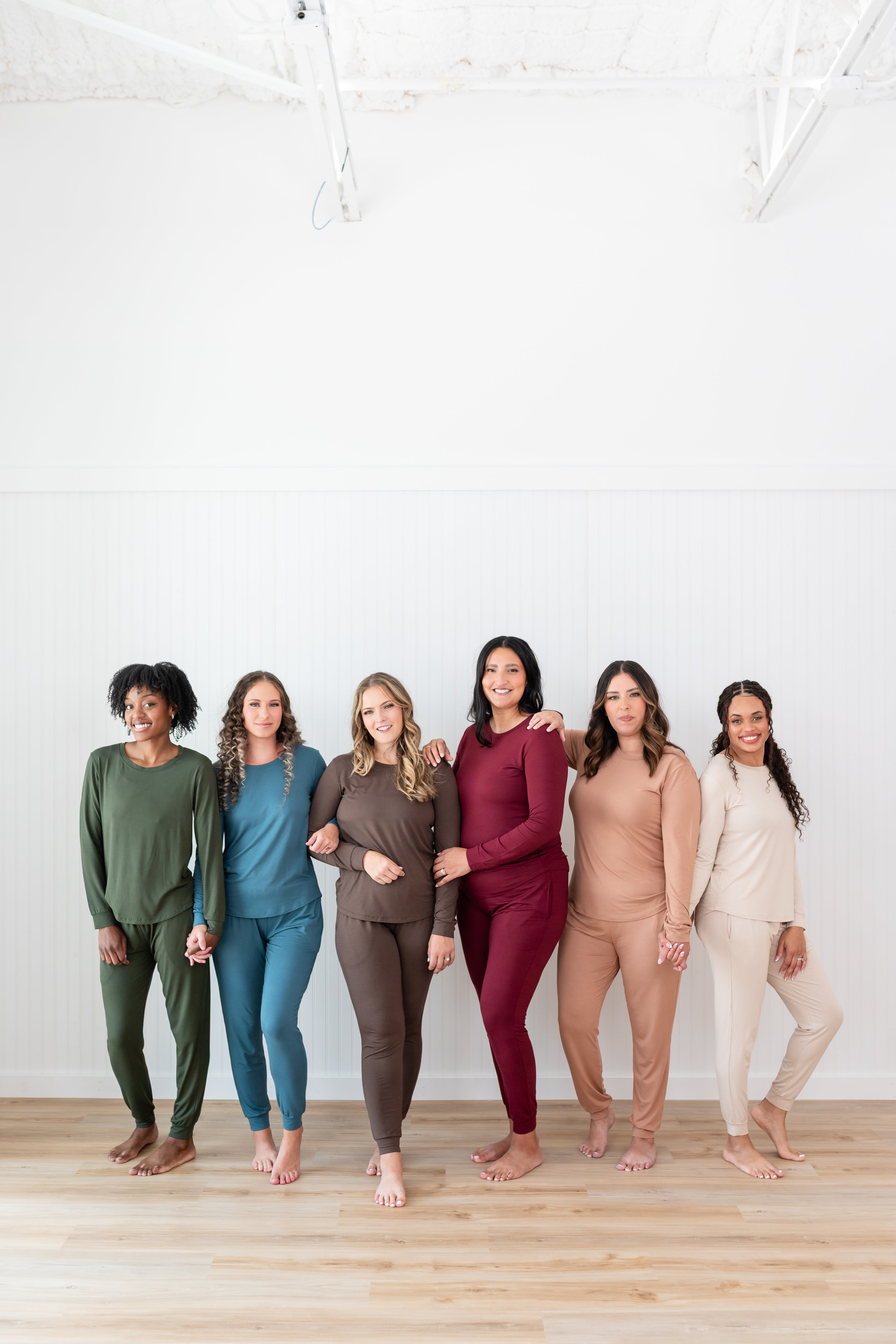 Women modeling the Kyte Women's Jogger Sets in Fir, Atlantic, Espresso, Burgundy, Latte and Bisque