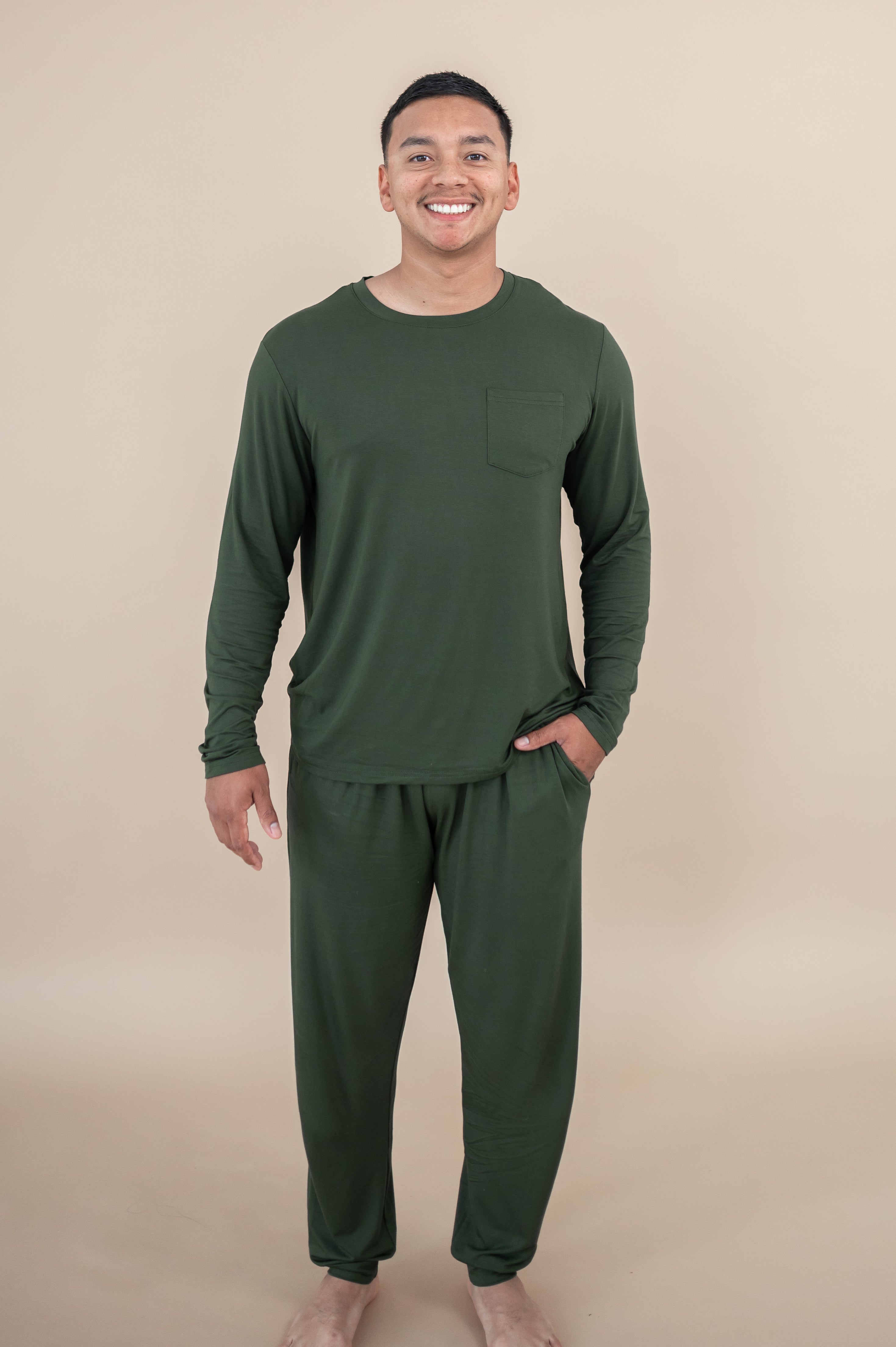 Smiling male model wearing Kyte Men's Jogger Set in Fir