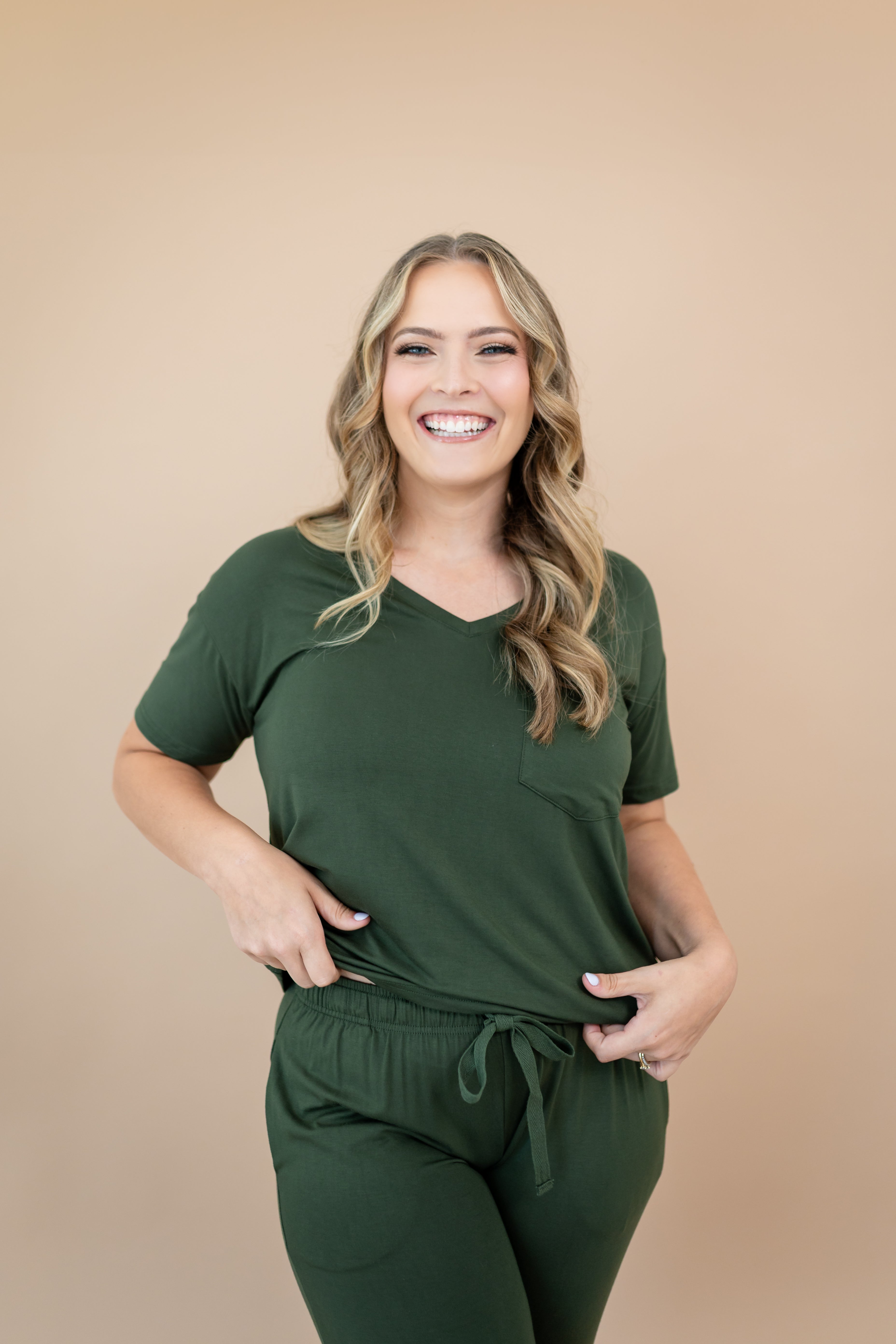Smiling model wearing the Women's V Neck in Fir