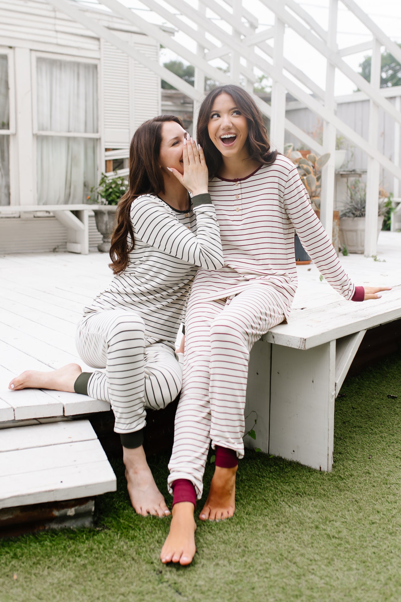 Model in Women’s Ribbed Henley Set in Fir Stripe whispering to model in Women’s Ribbed Henley Set in Burgundy Stripe