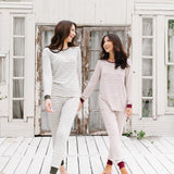 Two models holding hands and smiling at each other while wearing the Women's RIbbed Henley Set in Fir Stripe and Burgundy Stripe