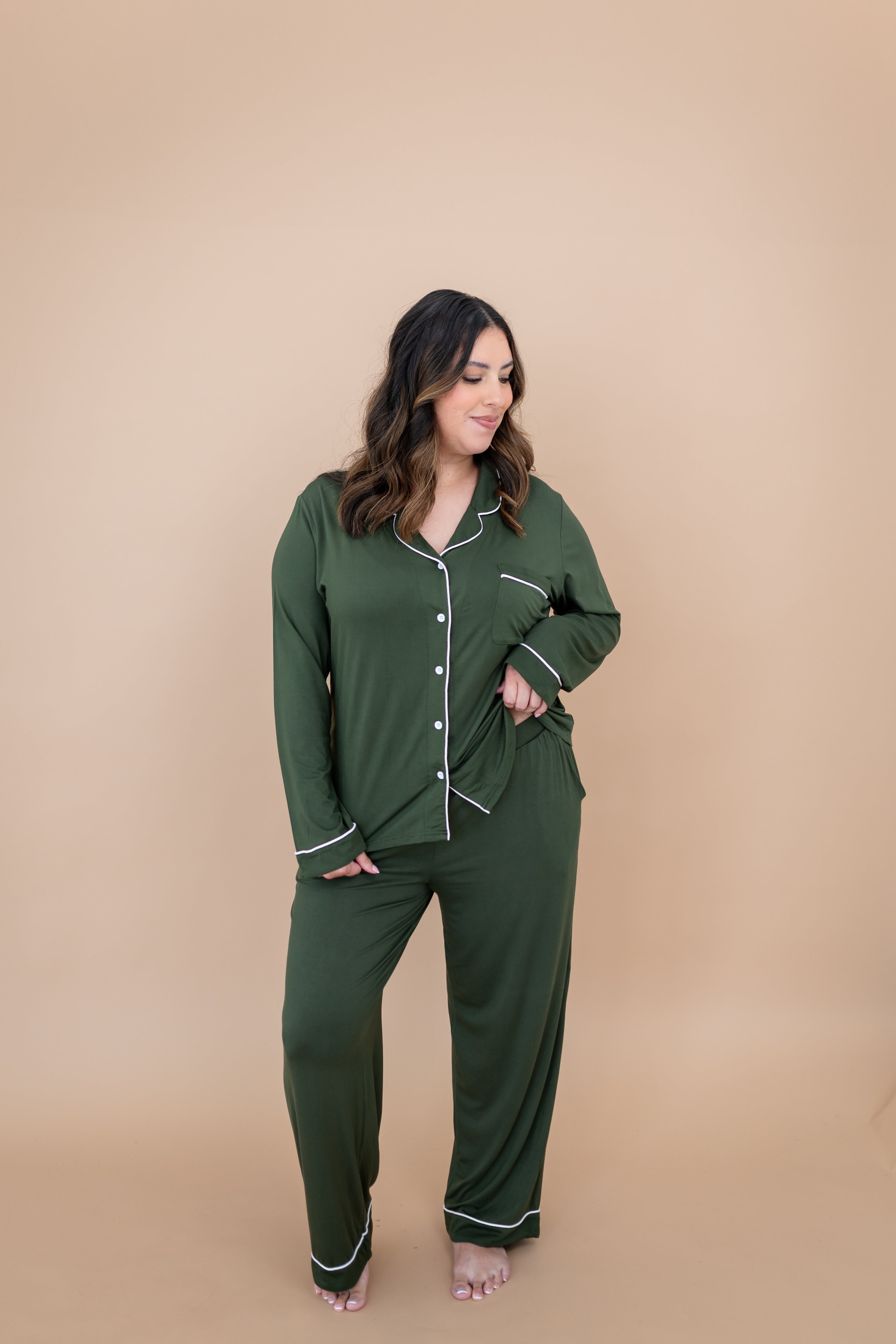 Smiling model looking down to the side while wearing the Women's Long Sleeve Pajama Set in Fir