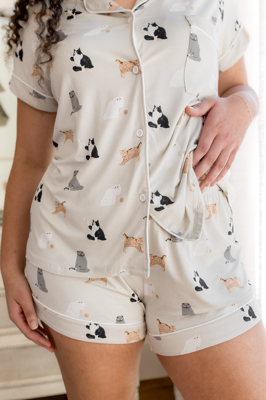 Person wearing Women's short sleeve pajama set with white trim in Fluffy Cat print