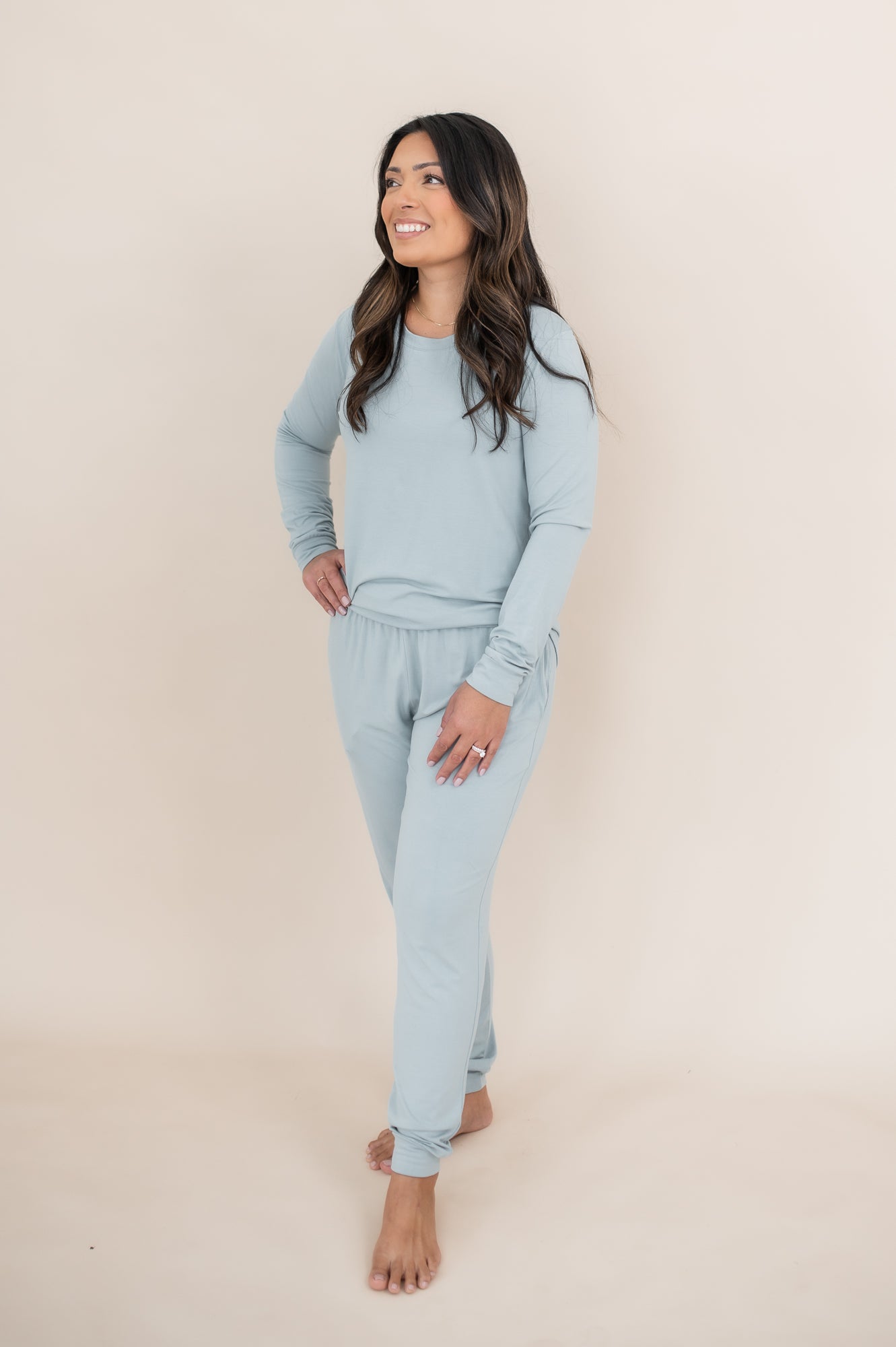 Model looking upwards to the side while wearing the Kyte Woman's Jogger Set in Fog