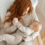 Woman nursing baby wearing the Women's French Terry Nursing Hoodie in Almond
