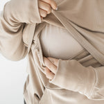 Front of the fabric pulled up while under layer is pulled down to show the functionality for breastfeeding in the Women's French Terry Nursing Hoodie in Almond